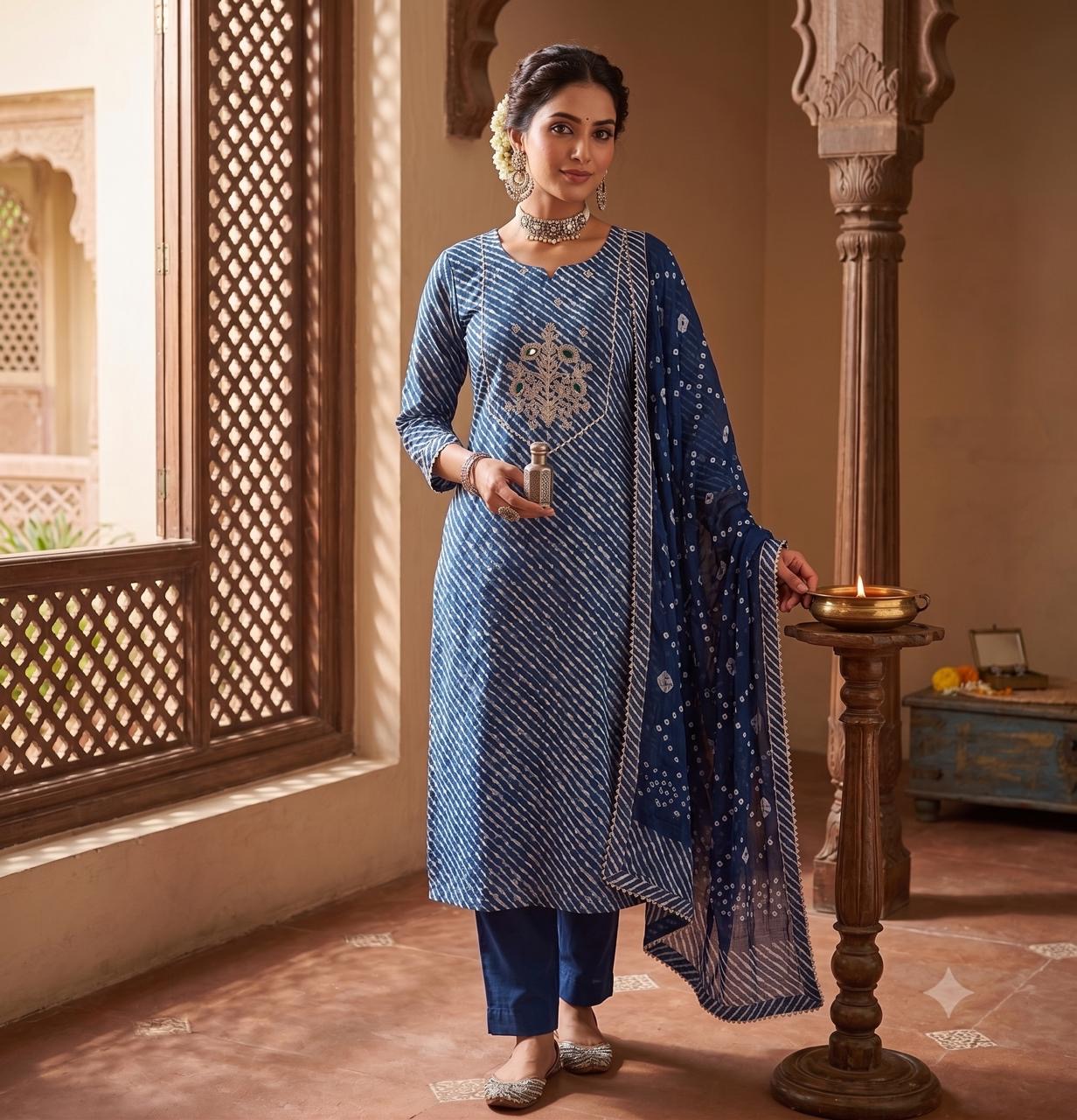 The Midnight Leheriya Suit Set worn beside a carved jharokha